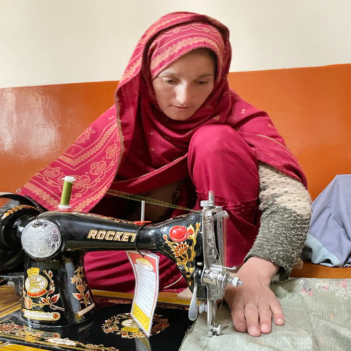 Women in Pakistan sewing clothes as part of a skills training program.